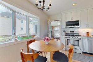 a kitchen with a table and chairs and a dining room at Harbor Point Cottage in Bourne