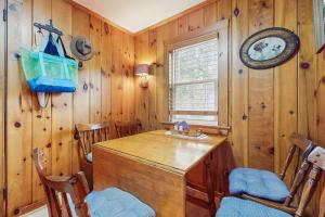a dining room with a wooden table and chairs at Uncle Rolfs Cozy Cottage in Dennis Port