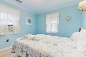 a blue bedroom with a bed with stars on it at Uncle Rolfs Cozy Cottage in Dennis Port +7 photos