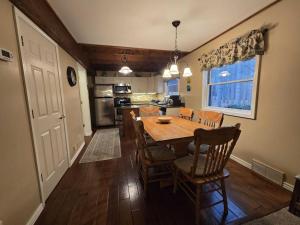 a kitchen and dining room with a table and chairs at Saltbox in Thompsonville