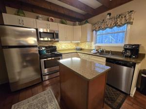 a kitchen with stainless steel appliances and a window at Saltbox in Thompsonville