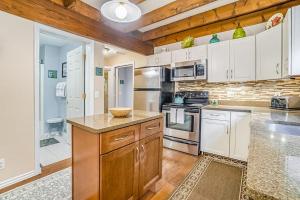 a kitchen with white appliances and wooden cabinets at Saltbox in Thompsonville