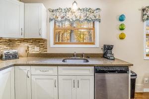 a kitchen with a sink and a window at Saltbox in Thompsonville +21 photos