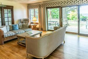 a living room with a couch and a table at Casual Lake Living in Union Pier