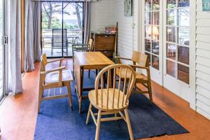 a dining room with a wooden table and chairs at Casual Lake Living in Union Pier