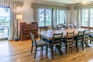 a dining room with a large wooden table and chairs at Casual Lake Living in Union Pier
