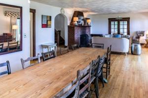 a large wooden table in a room with chairs at Casual Lake Living in Union Pier