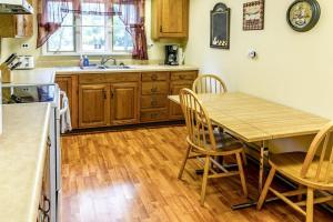 a kitchen with a table and chairs and a sink at Casual Lake Living in Union Pier +8 photos