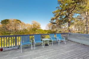 a group of chairs and tables on a deck at Soundmeadow House in Oak Bluffs