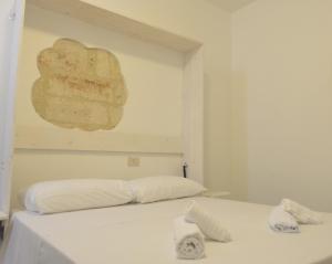 a bedroom with a bed with a painting on the wall at Casa Nannì in Polignano a Mare