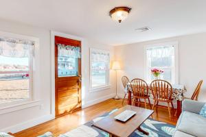 a living room with a couch and a table at Cataumet Cottage in Bourne