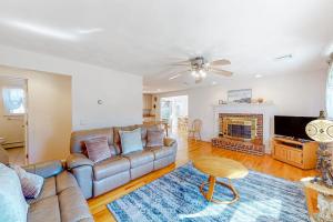 a living room with a couch and a fireplace at Cape Estate 6 in South Dennis