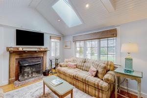 a living room with a couch and a fireplace at Seaside Park Retreat in West Hyannisport