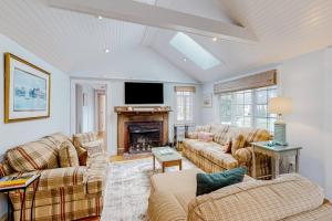 a living room with two couches and a fireplace at Seaside Park Retreat in West Hyannisport +40 photos