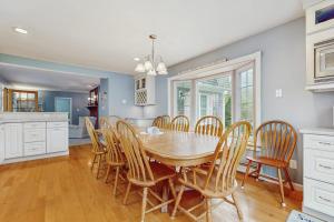 a kitchen and dining room with a table and chairs at Wharf Side Hideout in Hyannis