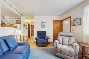 a living room with a blue couch and a chair at Hyannis Beach House in Hyannis