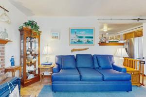 a living room with a blue couch in a room at Hyannis Beach House in Hyannis
