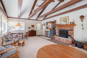 a living room with a table and a fireplace at Johnson Cottage in Glenn
