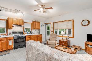 a living room with a couch and a kitchen at Lakeside Living in Lakeside