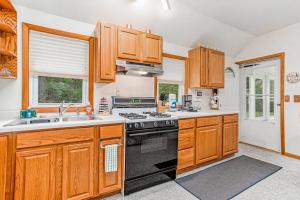 a kitchen with wooden cabinets and a stove top oven at Lakeside Living in Lakeside