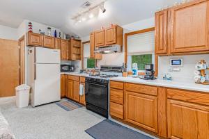 a kitchen with wooden cabinets and a white refrigerator at Lakeside Living in Lakeside +21 photos