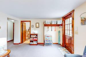 a living room with a shelf and a door at Nauset Beach Buddy in Orleans