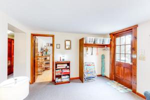 a room with a door and a shelf with books at Nauset Beach Buddy in Orleans +22 photos