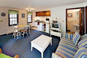 a living room with a couch and a table at Dennis Port Palace in Dennis Port