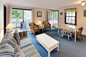 a living room with a couch and a table at Dennis Port Palace in Dennis Port