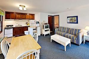 a kitchen and living room with a couch and a table at Dennis Port Palace in Dennis Port +17 photos