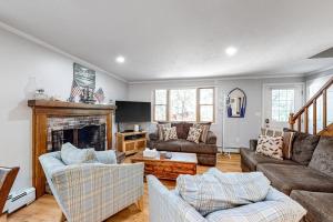 a living room with two couches and a fireplace at Lighthouse Lodge in Eastham