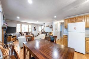 a kitchen and living room with a table and a refrigerator at Lighthouse Lodge in Eastham