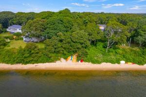 an aerial view of a beach with trees and a house at Dolce Vita in Falmouth