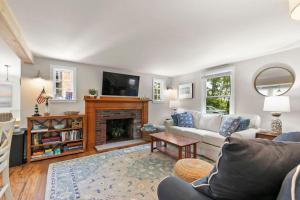 a living room with a couch and a fireplace at Dolce Vita in Falmouth