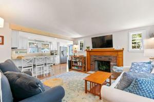 a living room with two couches and a fireplace at Dolce Vita in Falmouth +36 photos