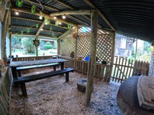 a wooden pavilion with a ping pong table in it at Chalé Cafofo in Campo Alegre +58 photos