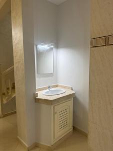 a bathroom with a sink and a mirror at Villa Familiale Exception in Saïdia +9 photos