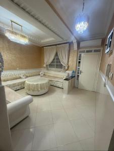 a large living room with a table and a couch at Villa Familiale Exception in Saïdia