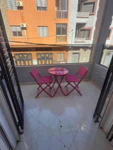 a patio with a table and two chairs on a balcony at Villa Familiale Exception in Saïdia