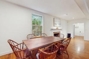 a dining room with a wooden table and chairs at Family Tides in Barnstable