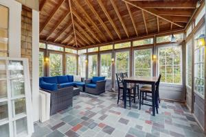 a screened in porch with a table and chairs at Family Tides in Barnstable +15 photos