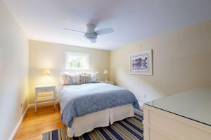 a bedroom with a bed and a window at Beach Happy in Harwich Port +30 photos