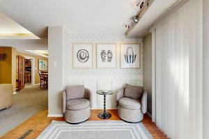 a living room with two chairs and a table at The Townline House in Union Pier