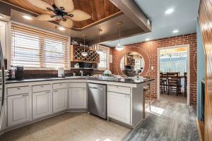a kitchen with white cabinets and a ceiling fan at The Townline House in Union Pier +27 photos