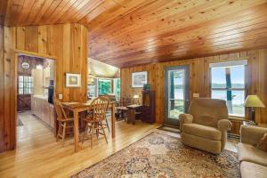 a living room with a dining room table and chairs at Serenity in Honor