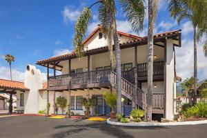 a view of the front of a resort with palm trees at FOUND Hotels, Santa Barbara, Series by Marriott in Santa Barbara
