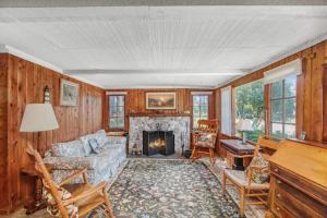 a living room with a couch and a fireplace at Cedar Cot & Cedar Tot in Beulah