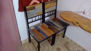a bench sitting in a room with a table at Cafe Romantique - Landhouse Style in Mérina