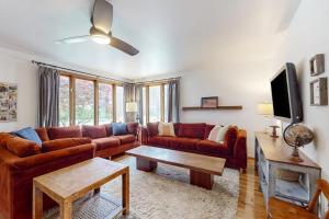 a living room with a couch and a tv at Steps from the Sand in Union Pier