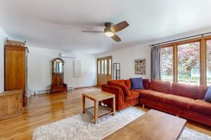 a living room with a couch and a table at Steps from the Sand in Union Pier